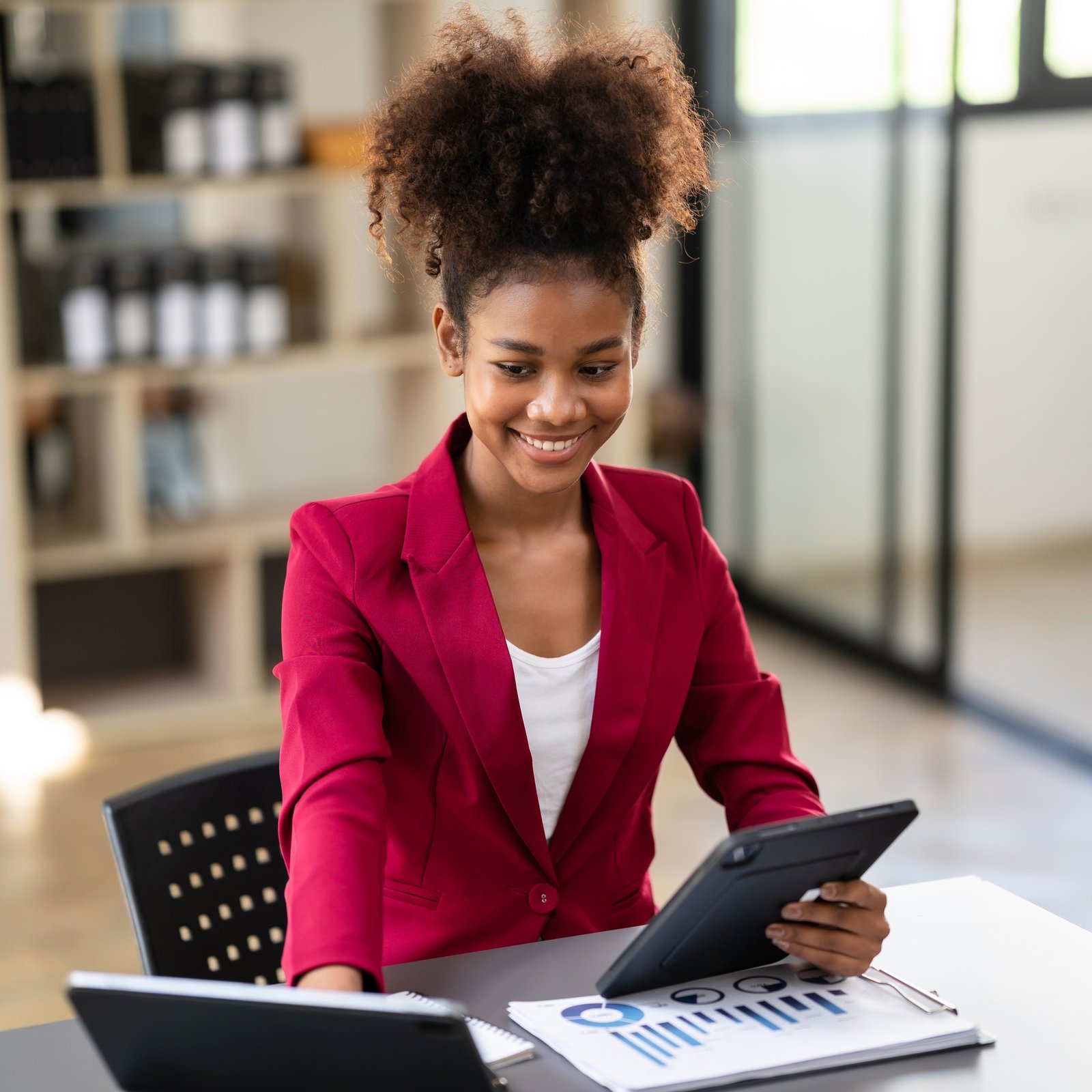 African american businesswoman in suit reading accounting inform